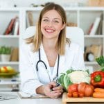 Nutrition-Expert-with-Healthy-Vegtables-on-a-cutting-board-and-an-open-laptop