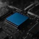 Close-up view of integrated circuits and microchips on a circuit board, showcasing technological details.