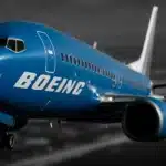 Boeing airplane flying over a landscape.