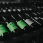 Rows of wine bottles in a cellar.