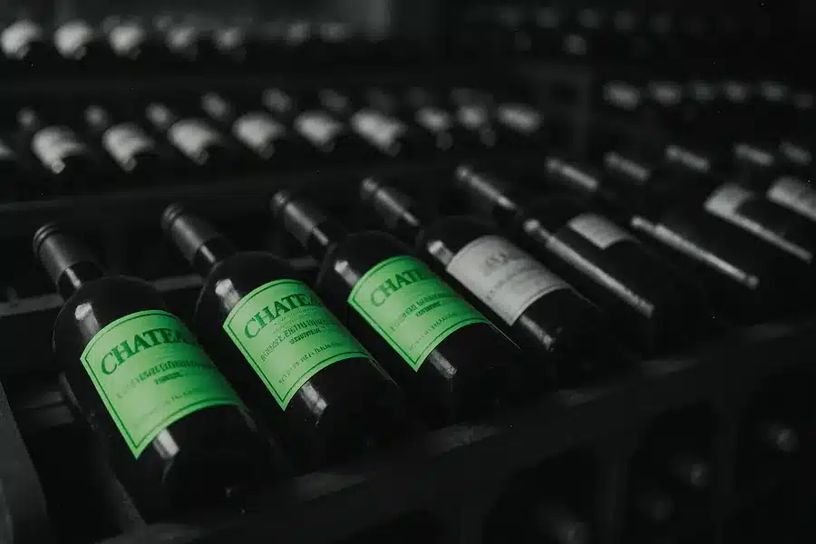 Rows of wine bottles in a cellar.