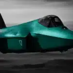 A fighter jet flying over a desert landscape.