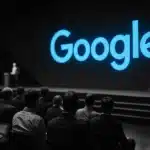 Conference with Google logo displayed on a large screen.