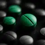 Overhead view of blue medical pills arranged in a pattern.