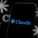 Claude app logo on a smartphone screen over a background with the same logo.