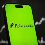 Robinhood app displayed on a smartphone with a financial chart backdrop.