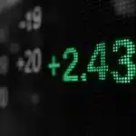 Digital stock market display with numbers and data visually highlighted.