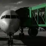 Front view of a Delta Air Lines aircraft at the gate with passengers boarding.