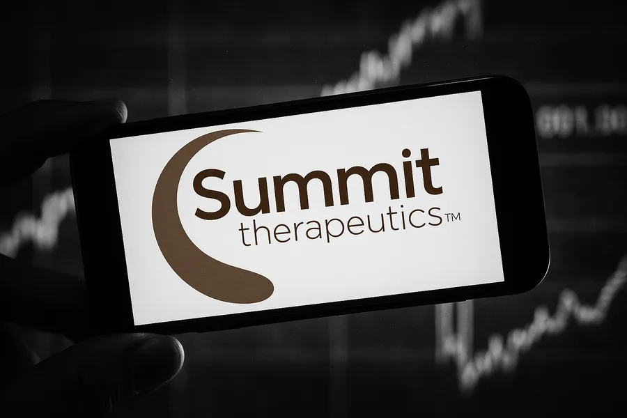 Smartphone displaying the Summit Therapeutics logo against a stock market background.