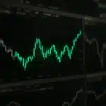 Stock market graphs on a screen.