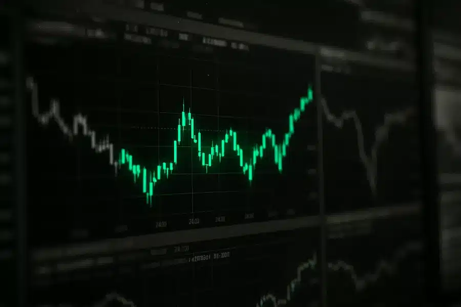 Stock market graphs on a screen.