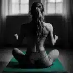A person sitting in a yoga pose wearing Lululemon attire.