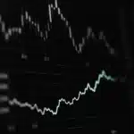 Graph and chart displaying market data on a digital screen.