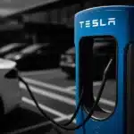 Tesla cars charging at a Tesla Supercharger station.