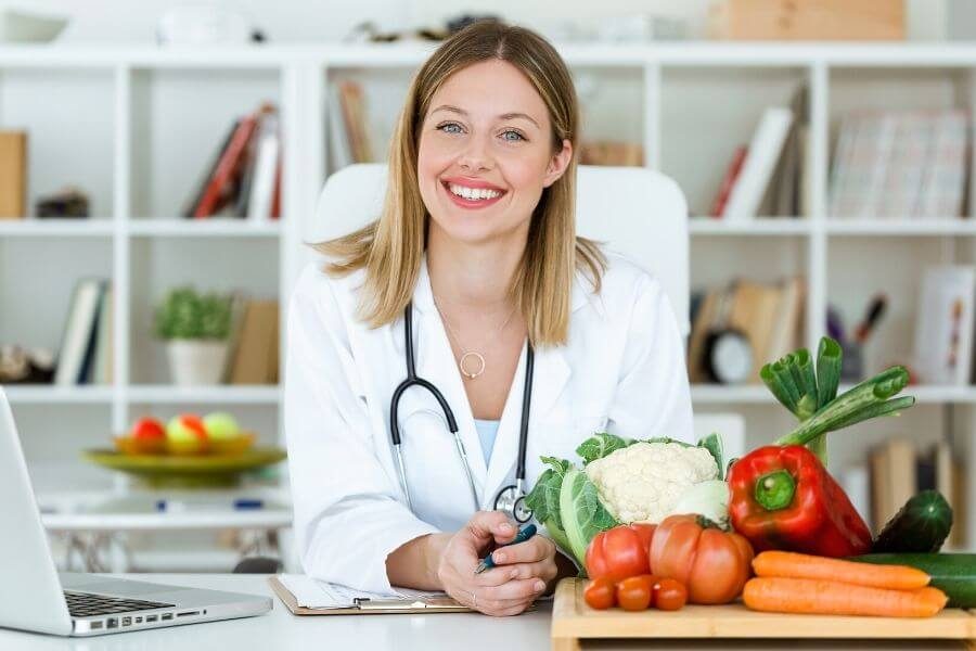 Nutrition-Expert-with-Healthy-Vegtables-on-a-cutting-board-and-an-open-laptop